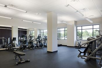 a gym with cardio machines and weights